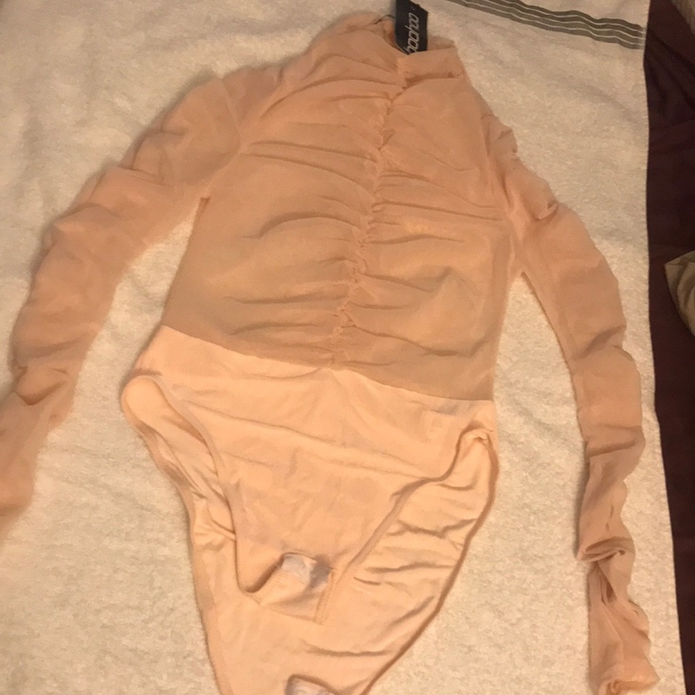 Mesh material for upper half. Mock neck.
